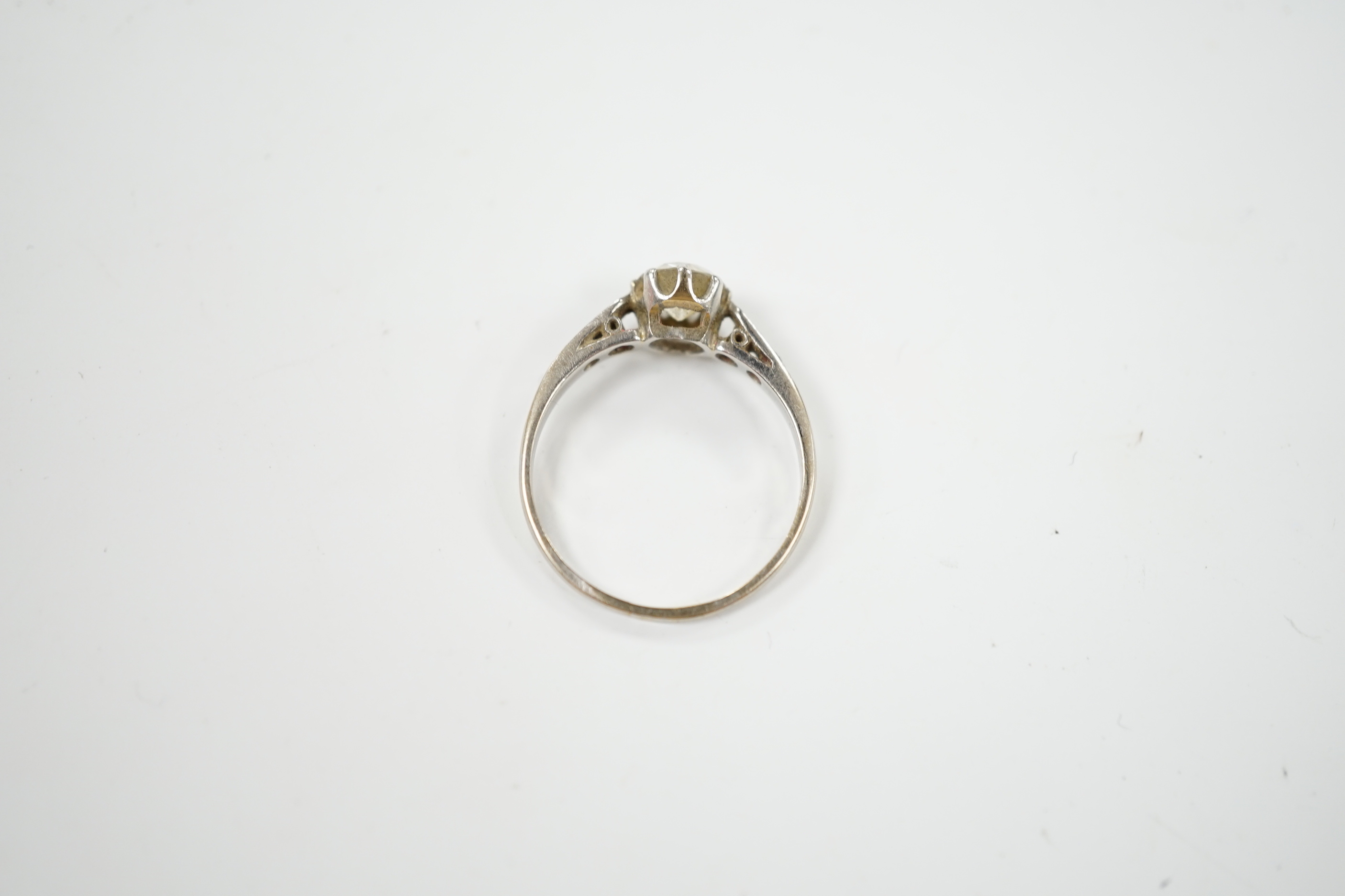 A white metal (stamped plat) and single stone diamond ring with diamond set shoulders, size M/N, gross weight 2.6 grams.